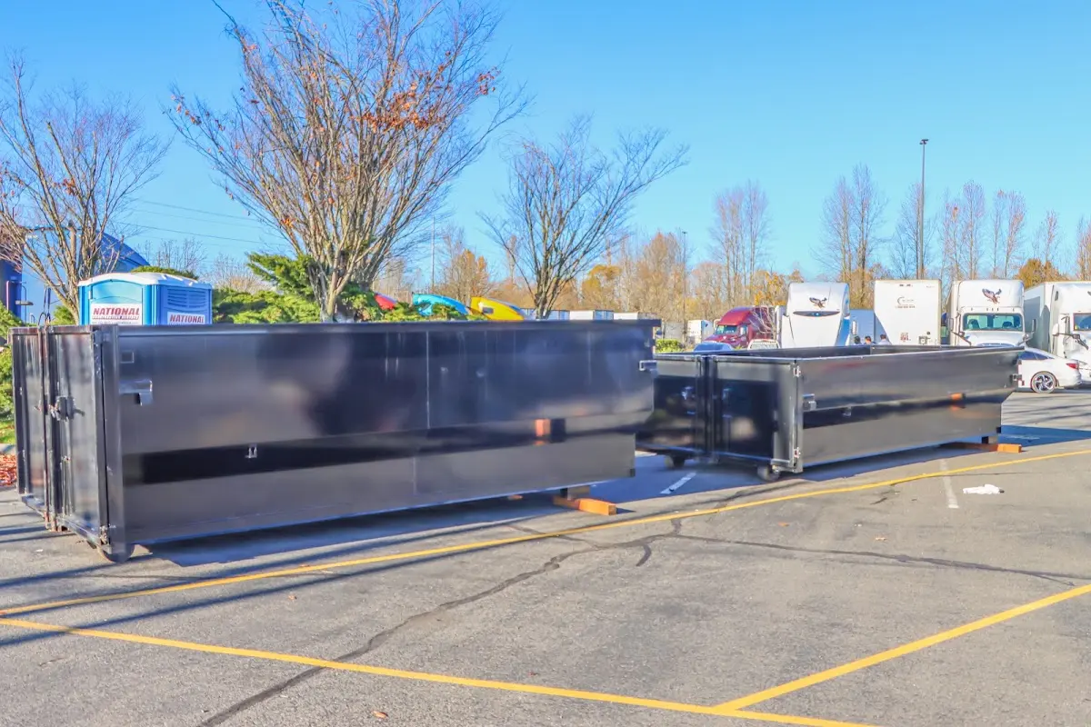 Professional dumpster rental service with roll-off container on residential driveway in St. Marys